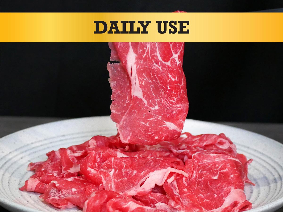 Raw beef slices on a plate with 'DAILY USE' text at the top.